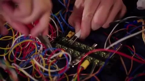 A big mess of wires being connected together by an electrician